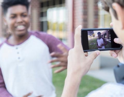 Student taking a photo of another student